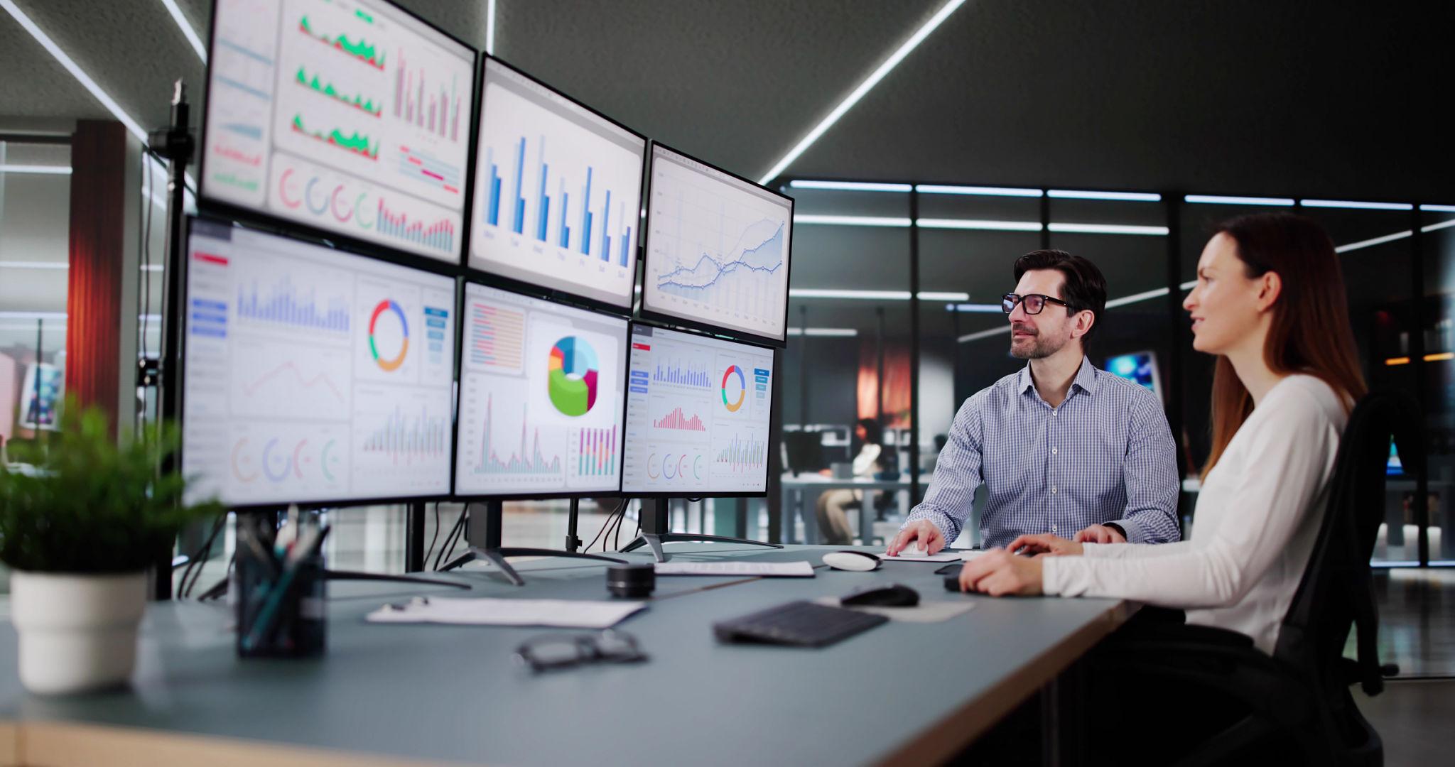 Business intelligence team evaluating build versus buy analytics solutions in a modern office