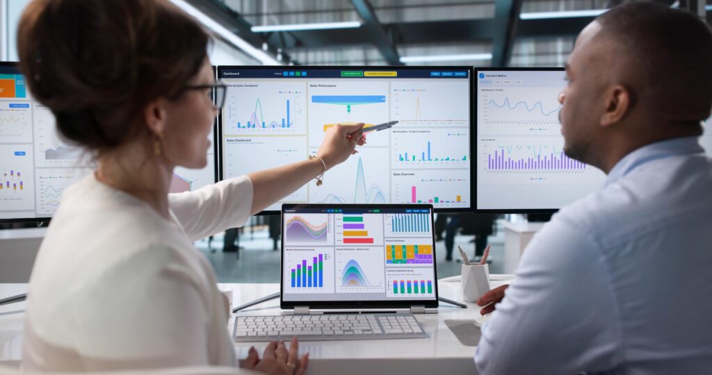 Data analysts comparing legacy and modern reports during reporting reconciliation