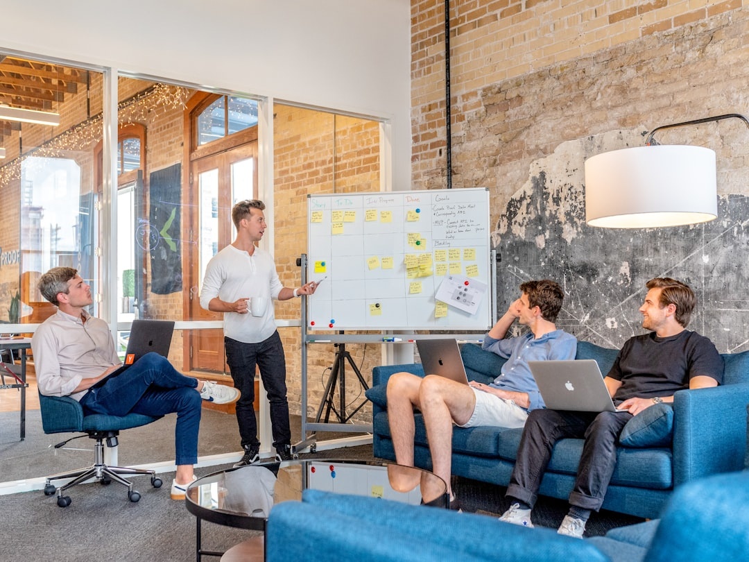 Product team collaborating around a whiteboard discussing application requirements