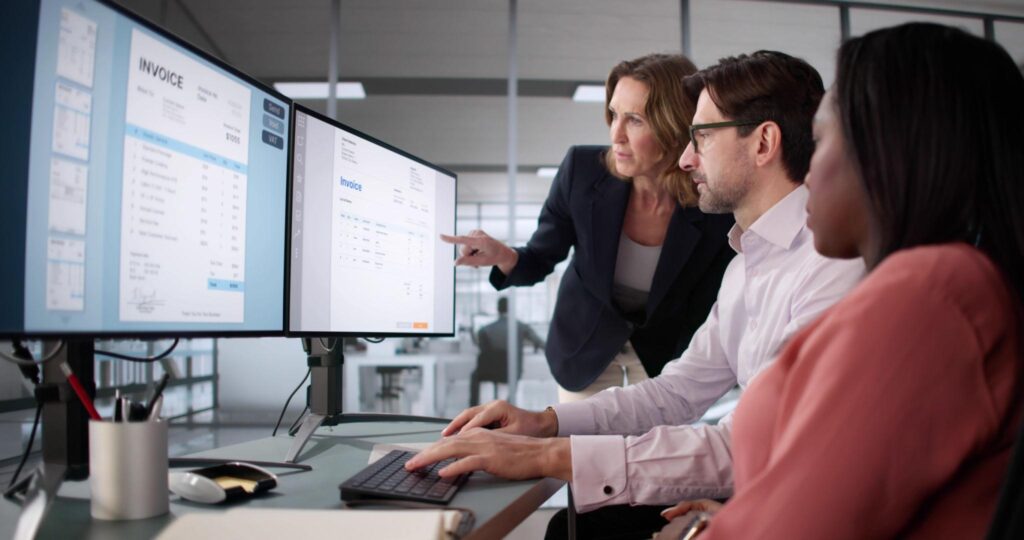 Accounting team reviewing invoice payment synchronization and financial reconciliation
