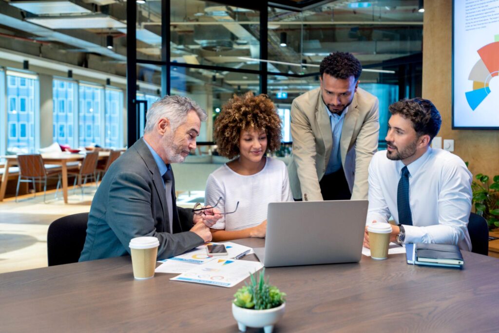 Business team collaborating on reports in a shared workspace