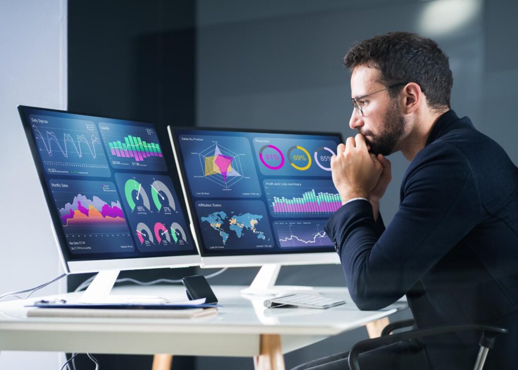 Data analyst reviewing business intelligence reports and data quality metrics