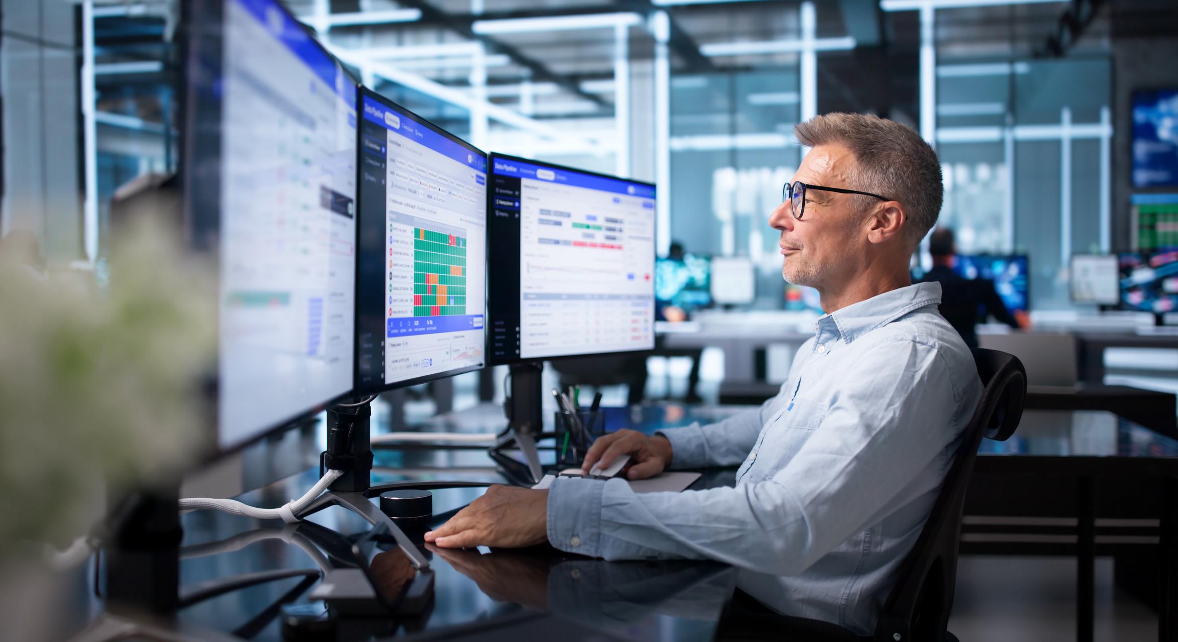 Database administrator monitoring operational data and analytics systems