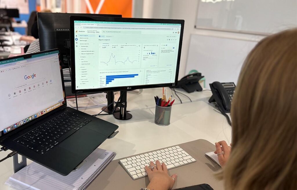 Marketing analyst reviewing google centric marketing reporting and analytics