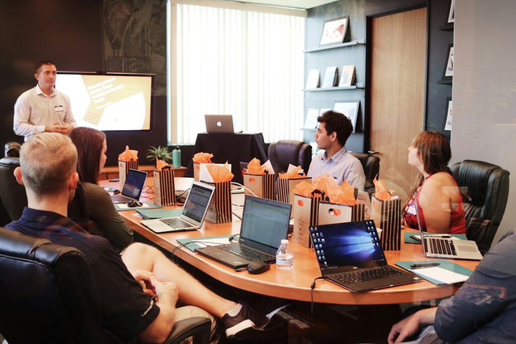 Project planning meeting in a corporate office illustrating rollout stages, governance, and business maturity paths.