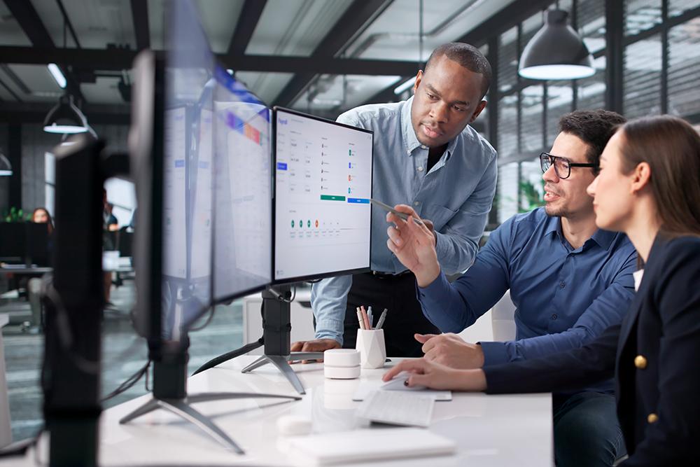 Software team reviewing mobile app maintenance metrics performance and technical health
